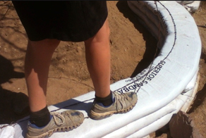 earthbag house construction - installing barbwire